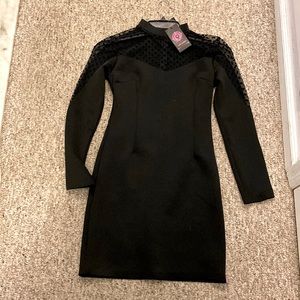 Little black dress. Sheer polka dot mock neck with sheer details down arms